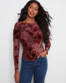 Elegant top with a flattering boat neckline, showcasing a floral pattern in rich hues. Perfect for any occasion. By Charlie B.