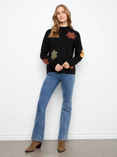 Floral appliqué embroidery creates an eye-catching detail that elevates the aesthetic appeal of this sweater. By Charlie B.