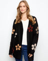 Black cardigan featuring bouclé floral details and long sleeves by Charlie B.