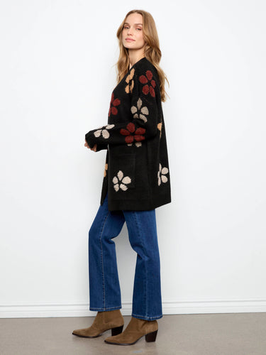 Chic black cardigan with convenient patch pockets and floral accents by Charlie B.