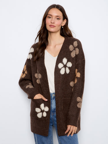 Bouclé floral details adorn this cozy cardigan, providing a unique texture and visual interest. Elegantly designed by Charlie B.