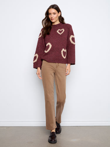 Elegant 3/4 bell sleeves paired with a relaxed silhouette make this burgundy heart-patterned sweater versatile for any occasion by Charlie B.
