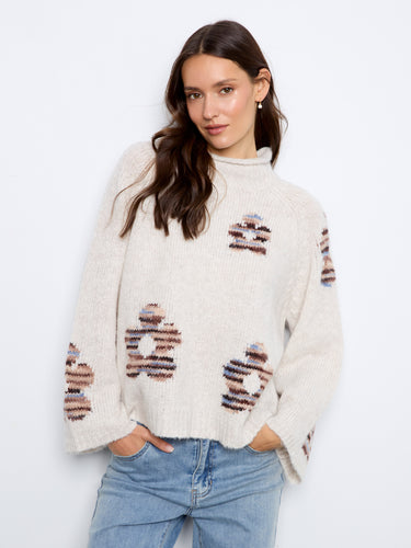 With its unique mock neck design, this sweater combines style and functionality seamlessly. By Charlie B.
