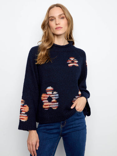 Navy sweater with colorful floral patterns and a mock neck, showcasing a relaxed fit design by Charlie B.