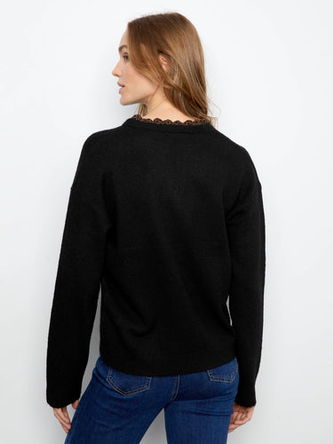 Trendy black sweater showcasing leopard print trim on the neckline for an edgy touch by Charlie B.