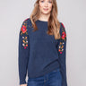 Denim sweater with a crew neckline and floral embroidery, adding elegance to casual wear by Charlie B.
