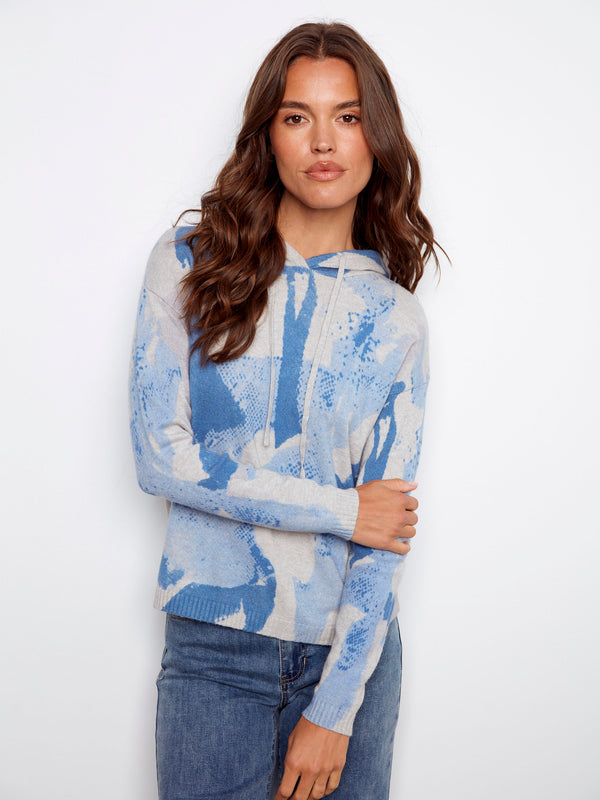 Enjoy the cozy feel of this blue abstract hoodie with its stylish knit cuffs by Charlie B.