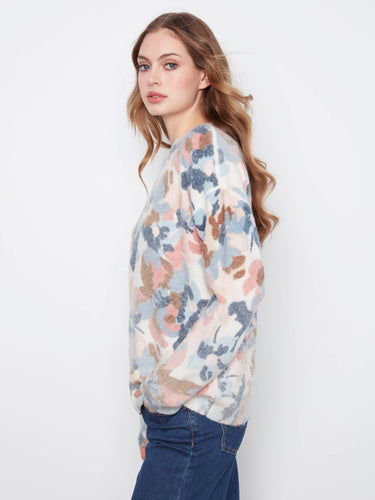 Crew neck styling ensures timeless elegance combined with modern floral prints on this soft fabric piece. By Charlie B.