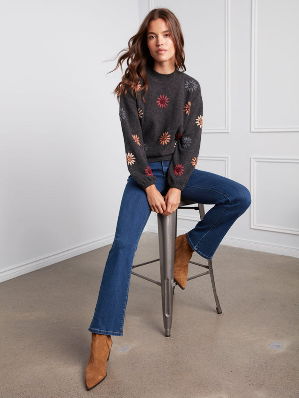 Stylish charcoal sweater with intricate floral details, designed with comfortable elastic cuffs by Charlie B.