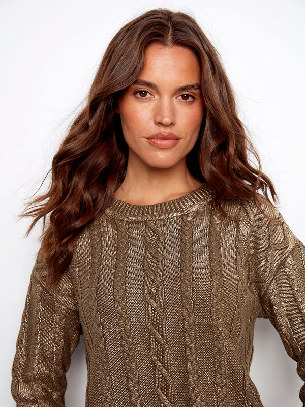Elegant cable knit sweater with shimmering metallic finish, perfect for elevating any casual look by Charlie B.