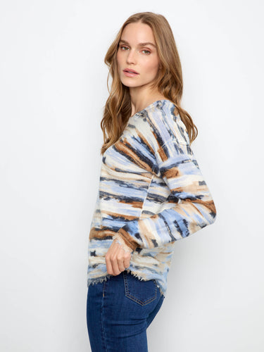 Featuring drop shoulders and distressed edges, this knitted piece combines comfort with contemporary fashion effortlessly. By Charlie B.