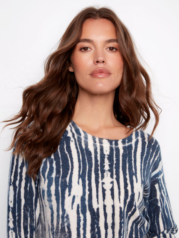 Fashionable plush sweater showcasing frayed edges for an edgy look by Charlie B.