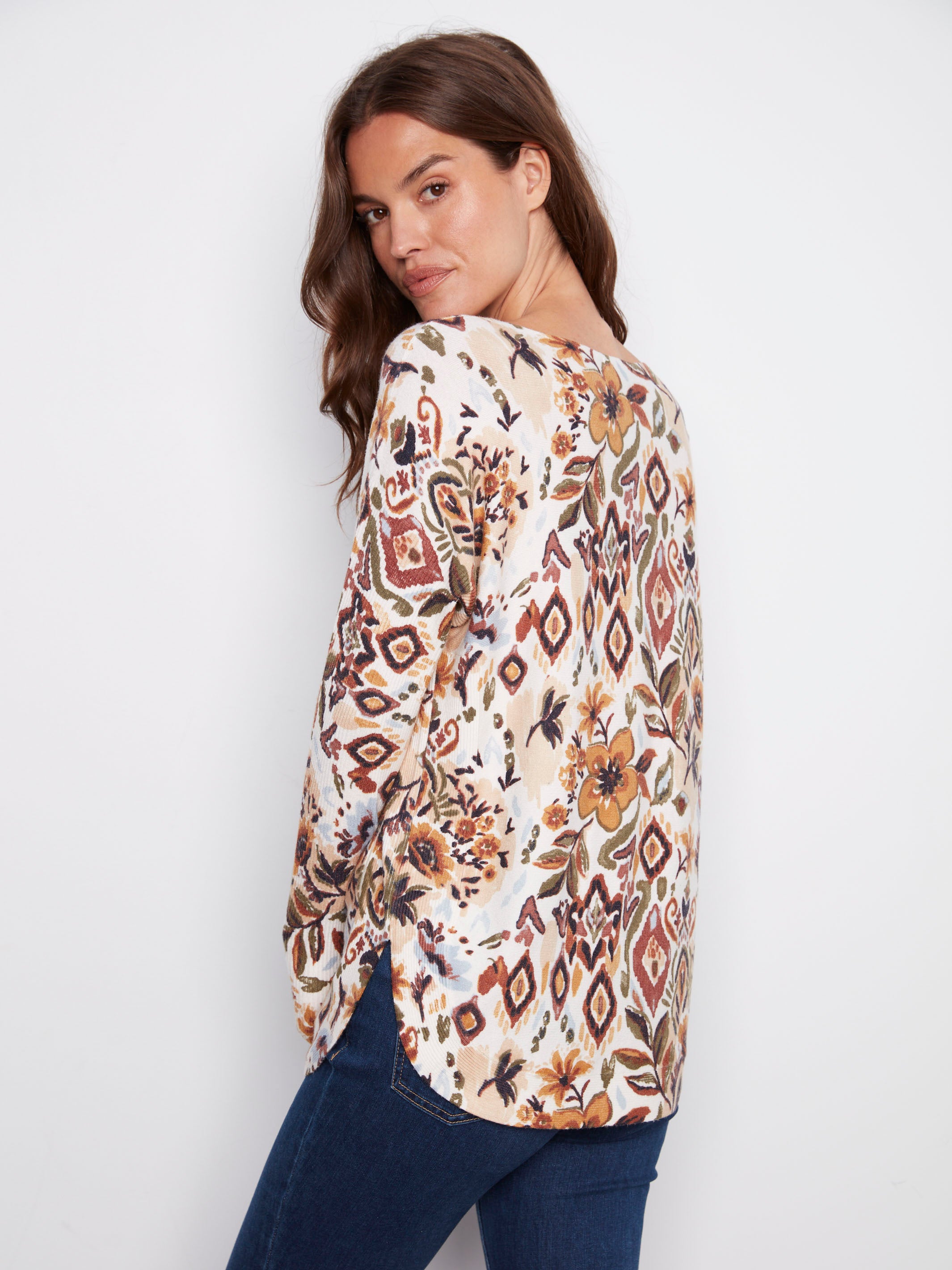 Stylish sweater showcasing side pockets and an intricate abstract floral motif, blending fashion with function by Charlie B.