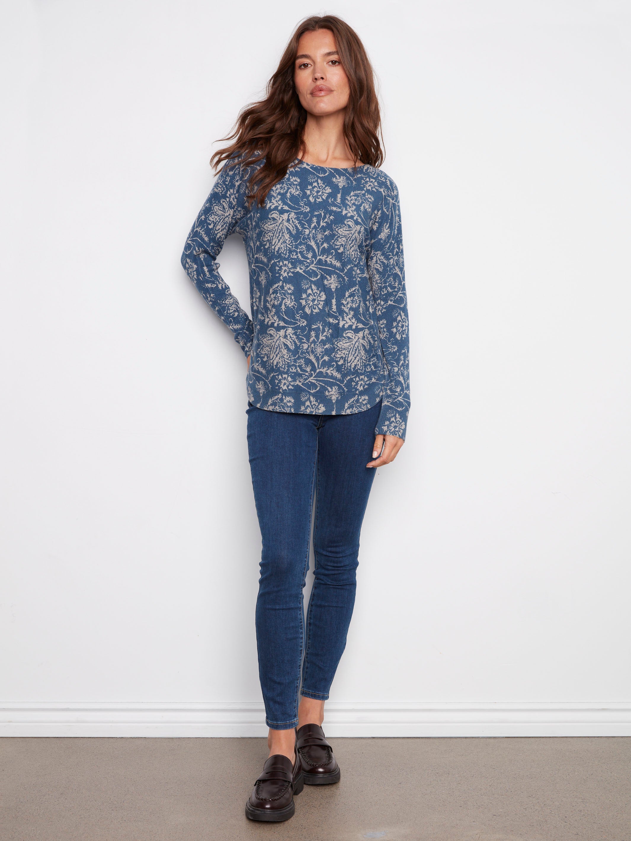 Stylish blue sweater with ribbed sleeves and an intricate floral pattern, ideal for layering by Charlie B.