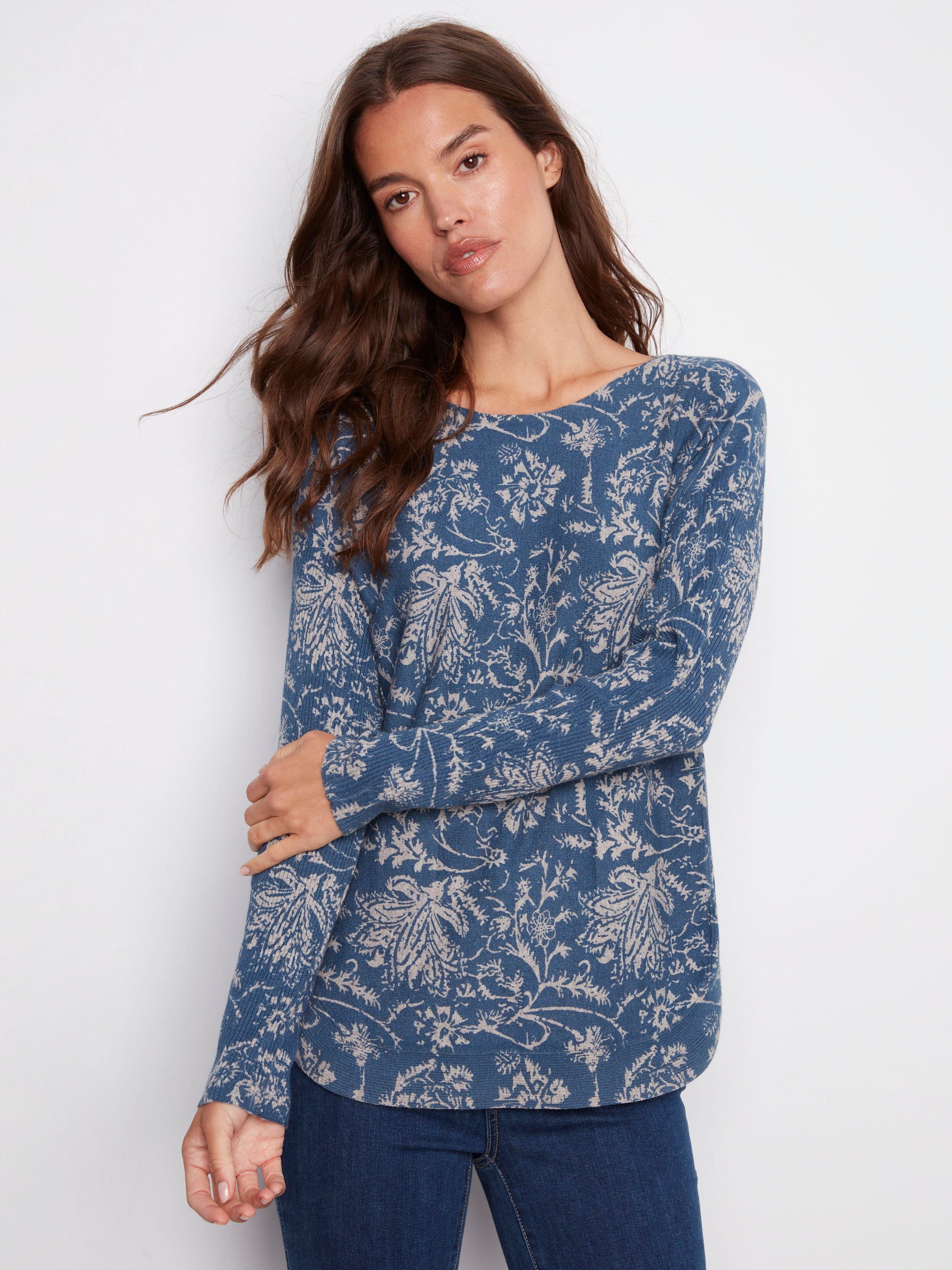 Elegant blue sweater showcasing side slits and a delicate floral print, adding charm to any outfit by Charlie B.