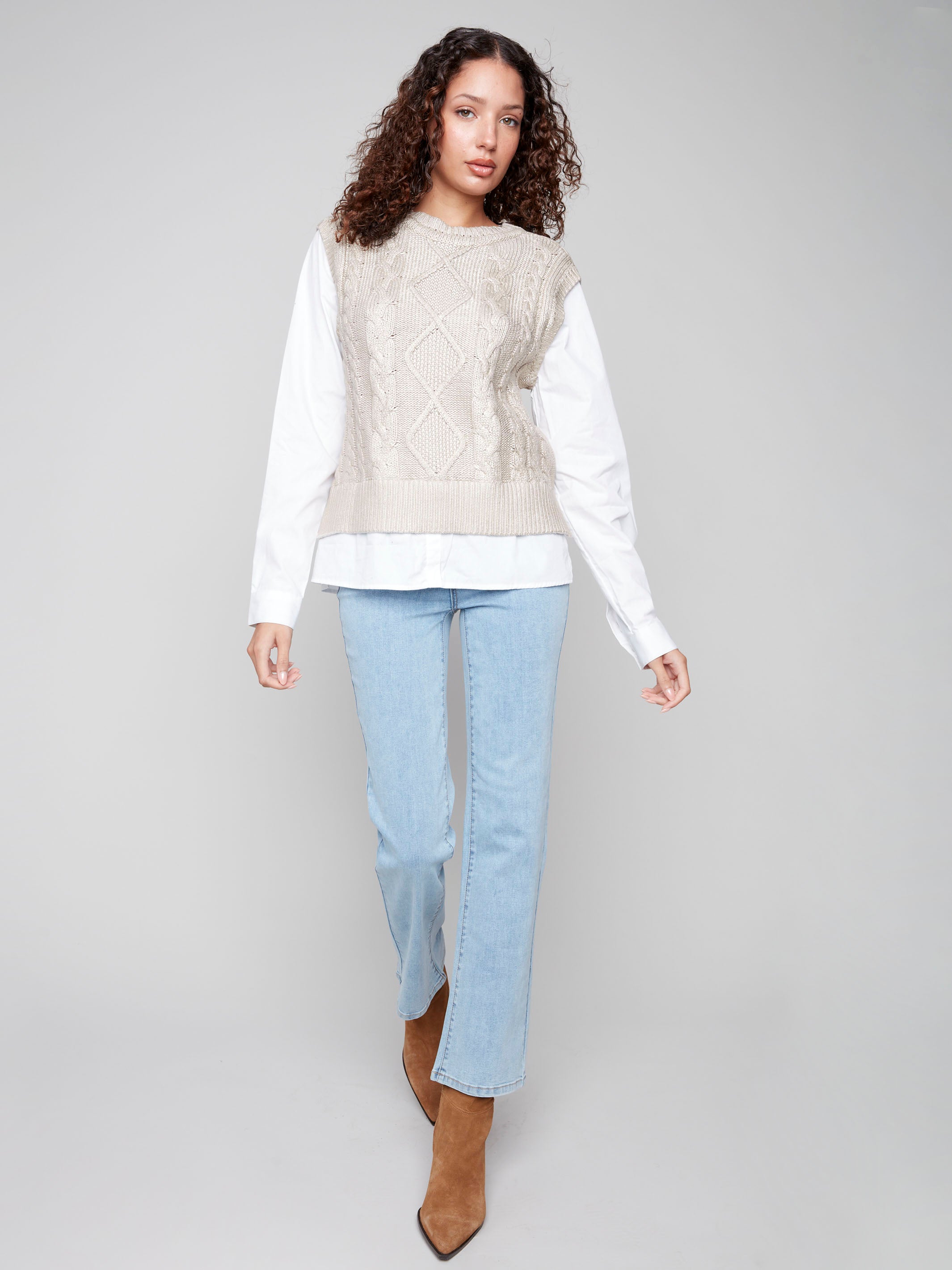Elegant sleeveless sweater vest in gold foil with crew neck, showcasing the intricate cable knit pattern for a stylish touch by Charlie B.
