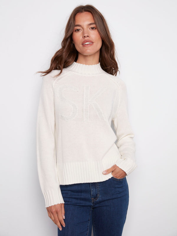 Ecru jacquard sweater featuring a mock neck and ribbed hem, highlighted by raglan sleeves for a relaxed fit by Charlie B.