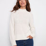 Ecru jacquard sweater featuring a mock neck and ribbed hem, highlighted by raglan sleeves for a relaxed fit by Charlie B.