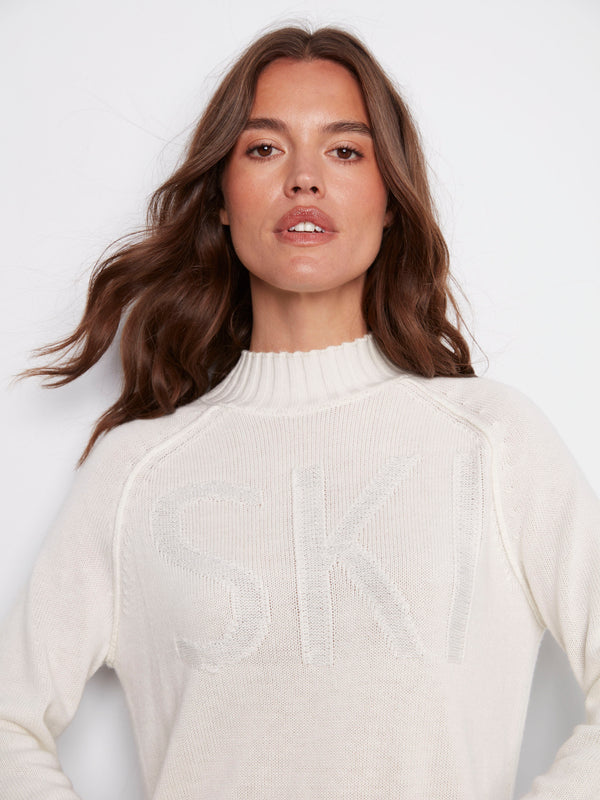 The 'SKI' jacquard pattern on this ecru sweater adds a playful touch to your winter wardrobe, complete with ribbed details by Charlie B.