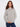 Heather light grey sweater with mock neck and ribbed hem, featuring raglan sleeves for a relaxed fit by Charlie B.