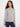 Light grey sweater crafted with raglan sleeves, PEACE jacquard design, and ribbed hemline for added style by Charlie B.
