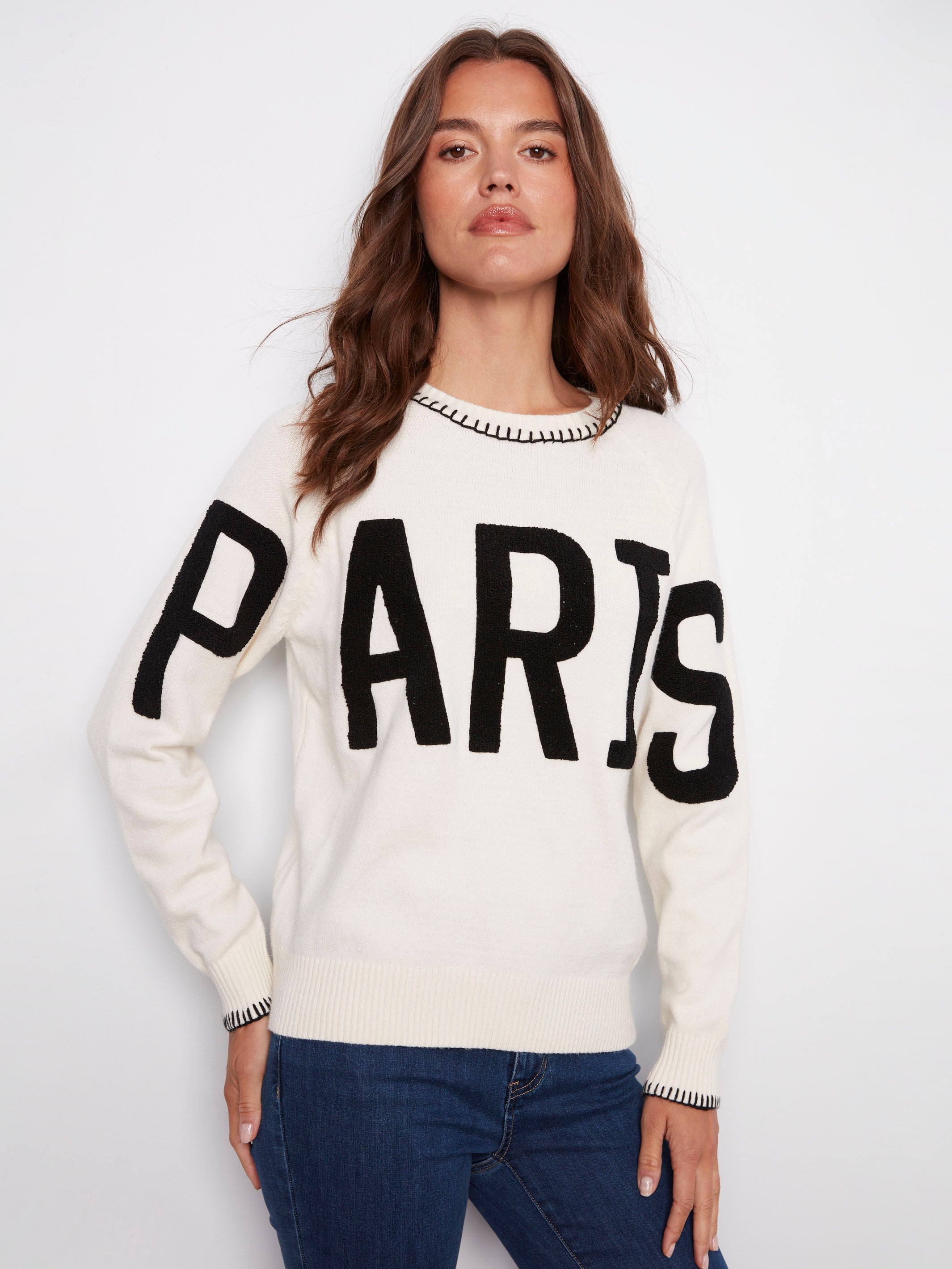 Elegant white sweater adorned with detailed blanket stitch accents and 'PARIS' embroidery by Charlie B.