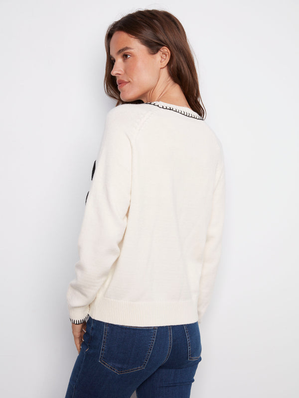 Soft white sweater showcasing intricate stitching and comfortable design, highlighted by the word 'PARIS' by Charlie B.