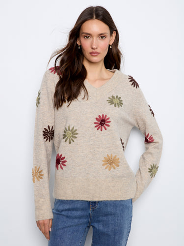 Sweater with a V-neck and vibrant floral embroidery, perfect for adding a touch of elegance to any outfit. By Charlie B.