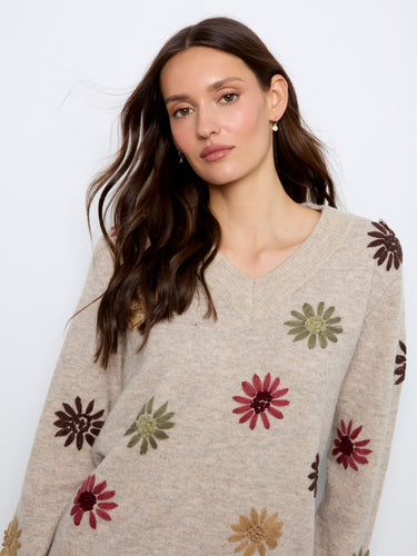 The ribbed cuffs and hem add a classic touch to the sweater, ensuring a snug fit and timeless appeal. By Charlie B.