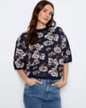 Floral knit sweater featuring a cozy mock neck, perfect for cooler days. By Charlie B.