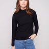Elegant black sweater with a chic mock neck, paired with casual blue jeans for a stylish look by Charlie B.