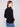Chic black textured sweater styled effortlessly with classic blue jeans for modern elegance by Charlie B.