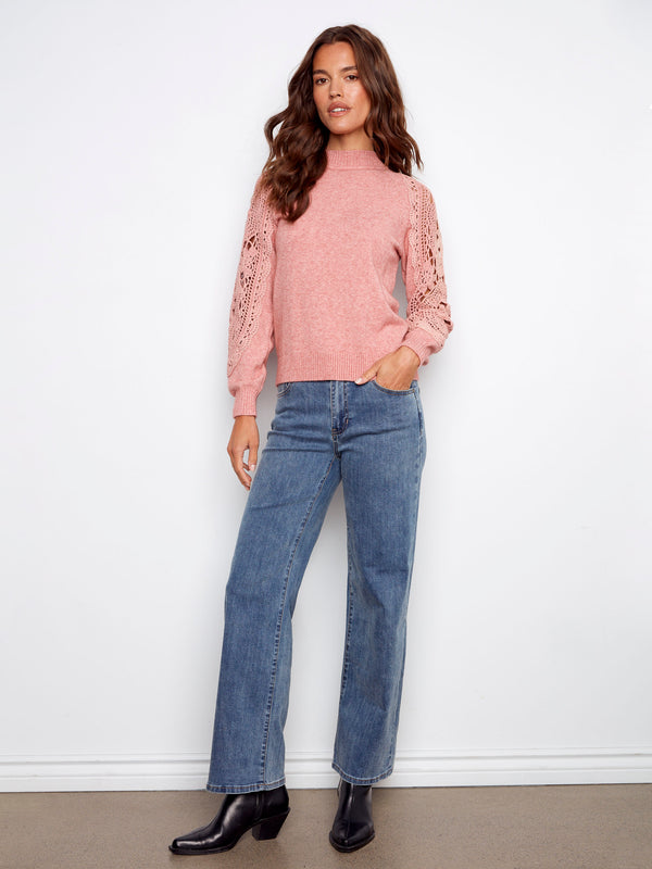 Heather primrose sweater showcasing intricate crochet details on the sleeves, enhancing its elegance by Charlie B.
