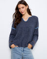 The sweater features a stylish notch neck with delicate detailing, perfect for a chic casual look by Charlie B.