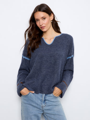 The sweater features a stylish notch neck with delicate detailing, perfect for a chic casual look by Charlie B.