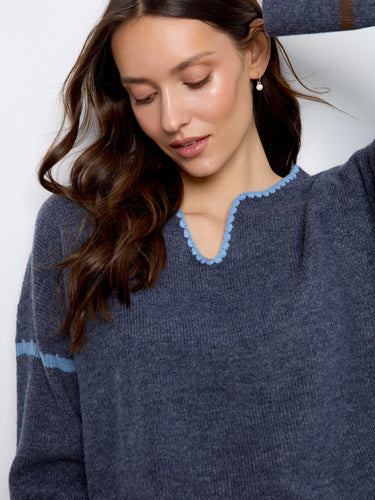 A stylish notch neck detail enhances the classic design of this cozy sweater, perfect for any season. By Charlie B.