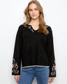 Black ribbed sweater with drop shoulders and floral embroidery on the sleeves by Charlie B.