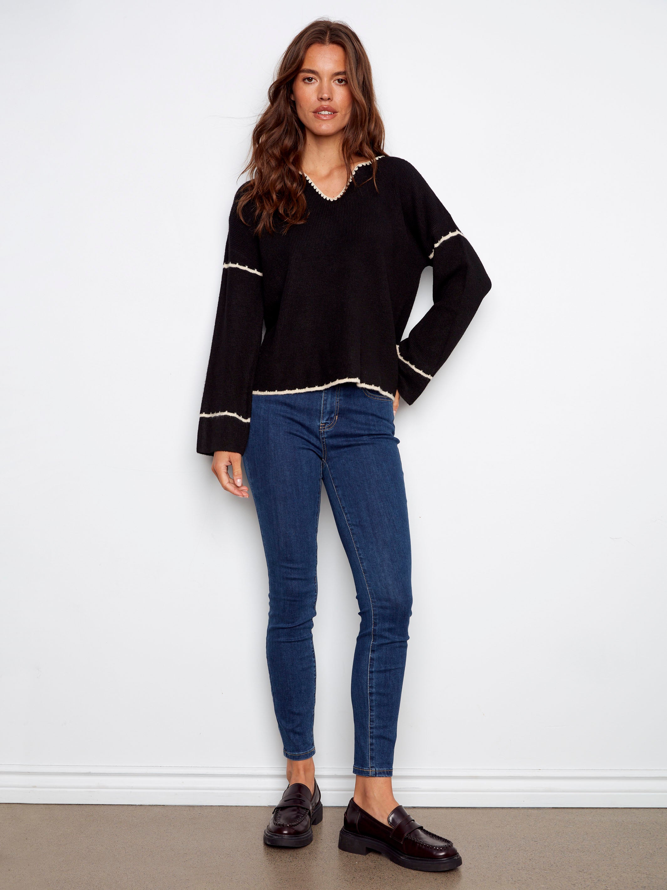 Chic black sweater showcasing an embroidered back design and relaxed fit for casual elegance by Charlie B.