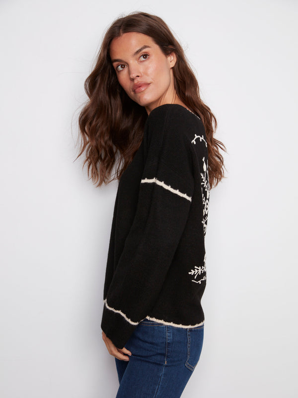 Sophisticated sweater in black with drop shoulders and unique white embroidery detailing by Charlie B.