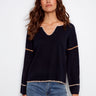 Navy sweater with drop shoulders and delicate white trim detail, creating a casual yet stylish look by Charlie B.