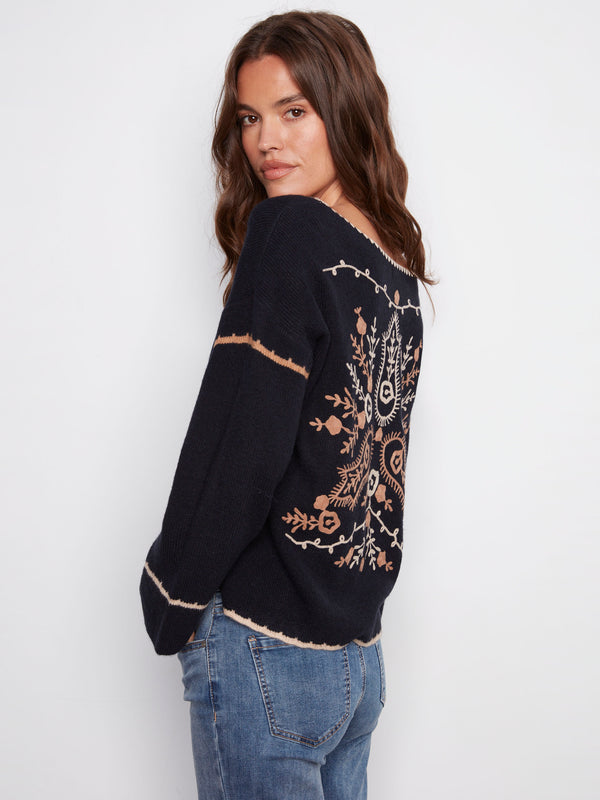 Elegant navy sweater featuring intricate embroidered back design in contrasting white for a chic touch by Charlie B.