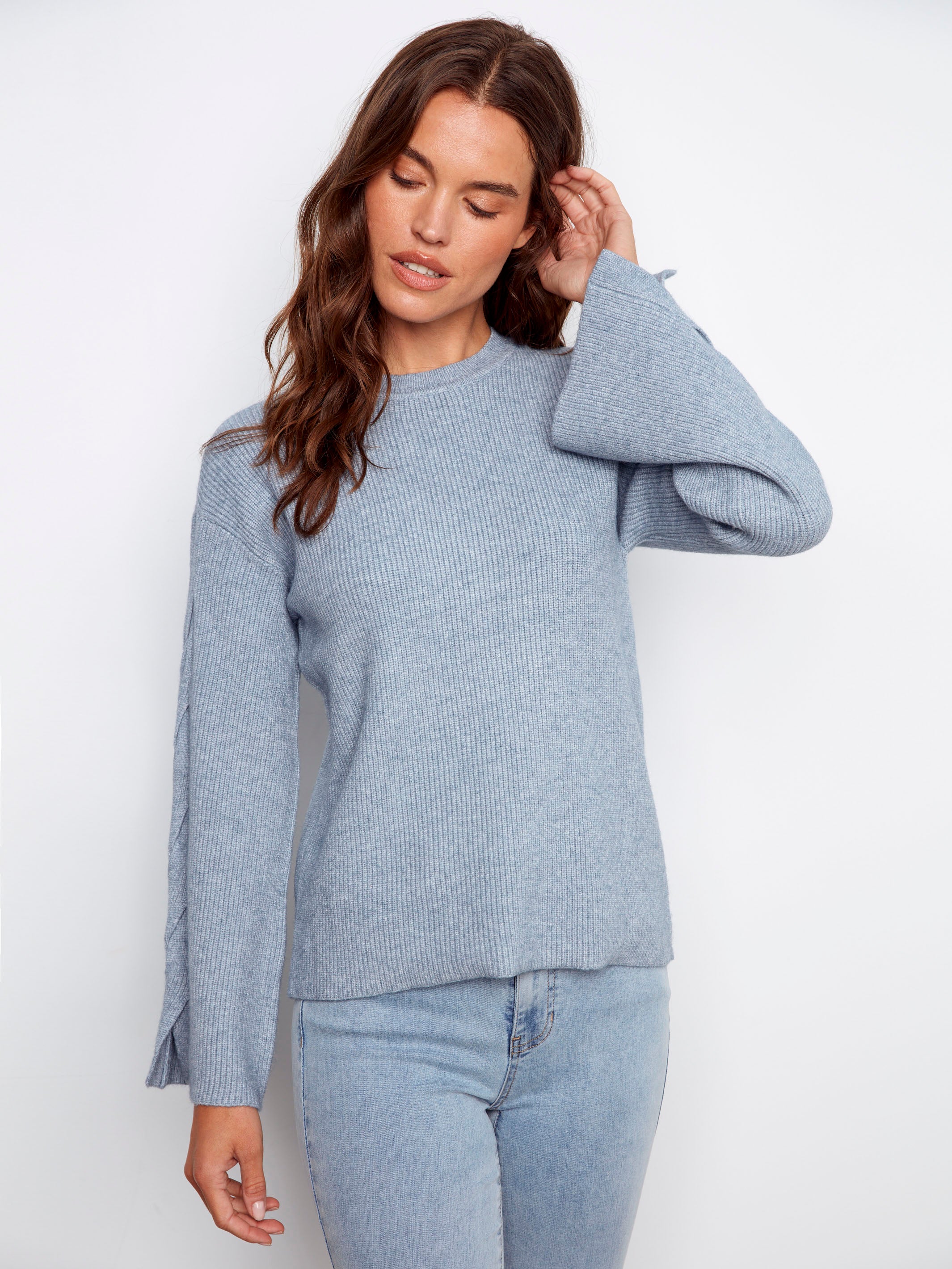 Stylish heather denim sweater with intricate cable sleeve details for added texture by Charlie B.