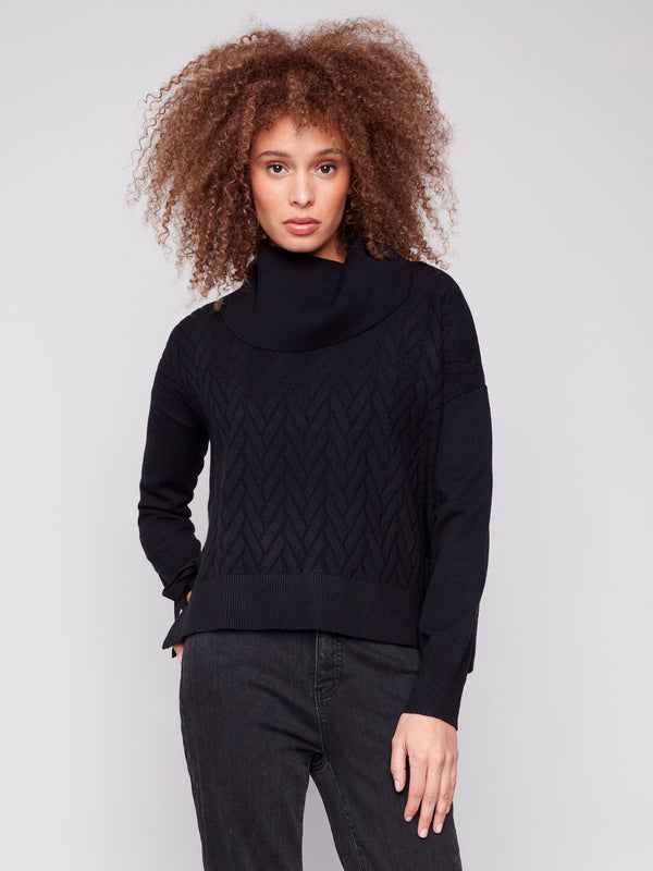 Black sweater featuring drop shoulders and chevron pattern, adding a relaxed fit by Charlie B.