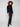 Chic black sweater showcasing side slit with tie detail, enhancing its modern look by Charlie B.