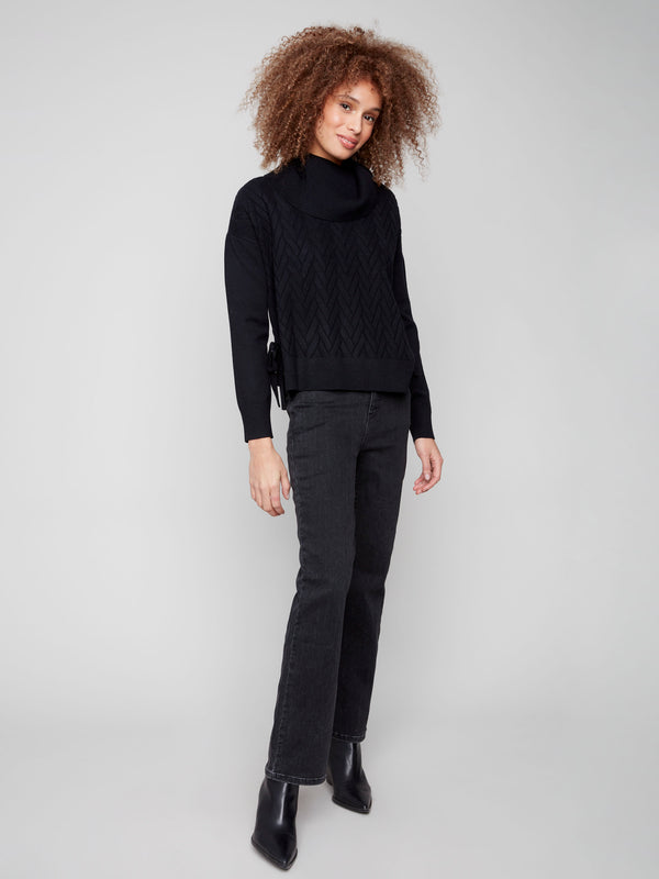 Chic black sweater showcasing side slit with tie detail, enhancing its modern look by Charlie B.