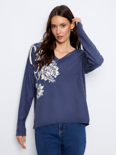 Elegant sweater with drop shoulders and long sleeves, offering a chic look with its intricate design. By Charlie B.