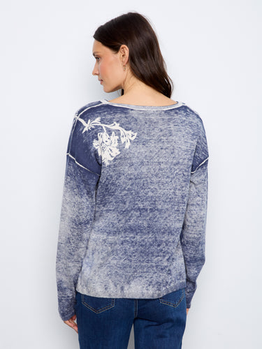 This elegant piece features long sleeves and drop shoulders, perfect for layering or wearing solo. By Charlie B.