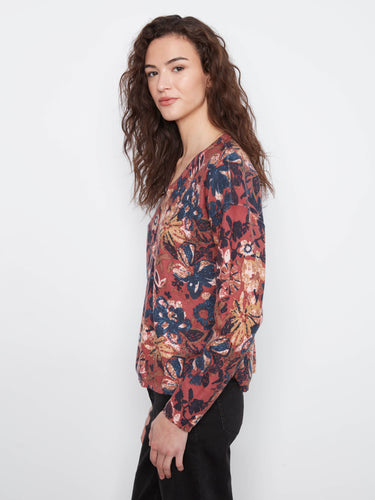 Stylish long sleeves complement the overall design of this versatile and chic floral print blouse. By Charlie B.