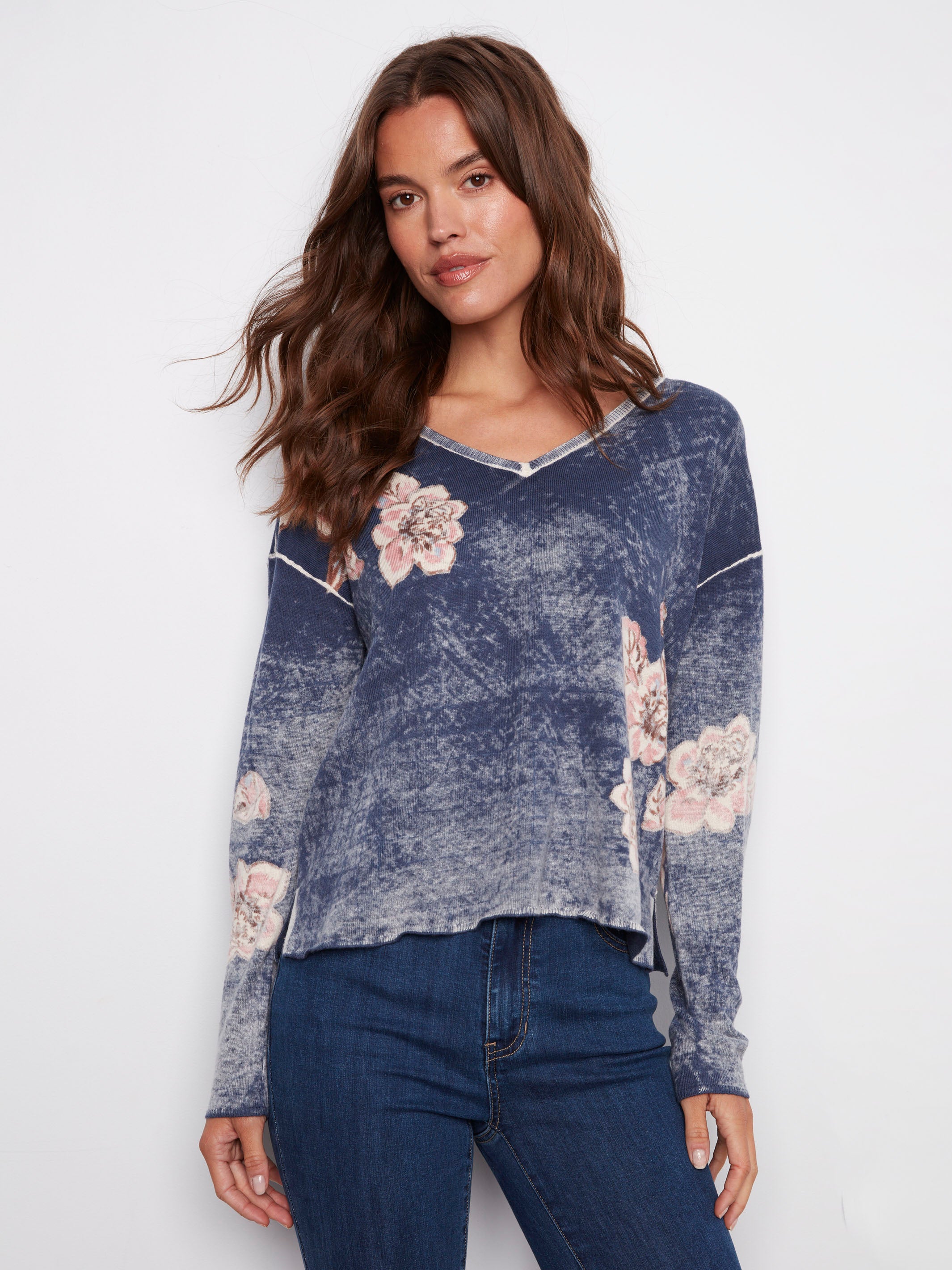 Denim blue sweater with a V-neck and floral print, showcasing its relaxed fit, by Charlie B.