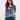 Denim blue sweater with a V-neck and floral print, showcasing its relaxed fit, by Charlie B.